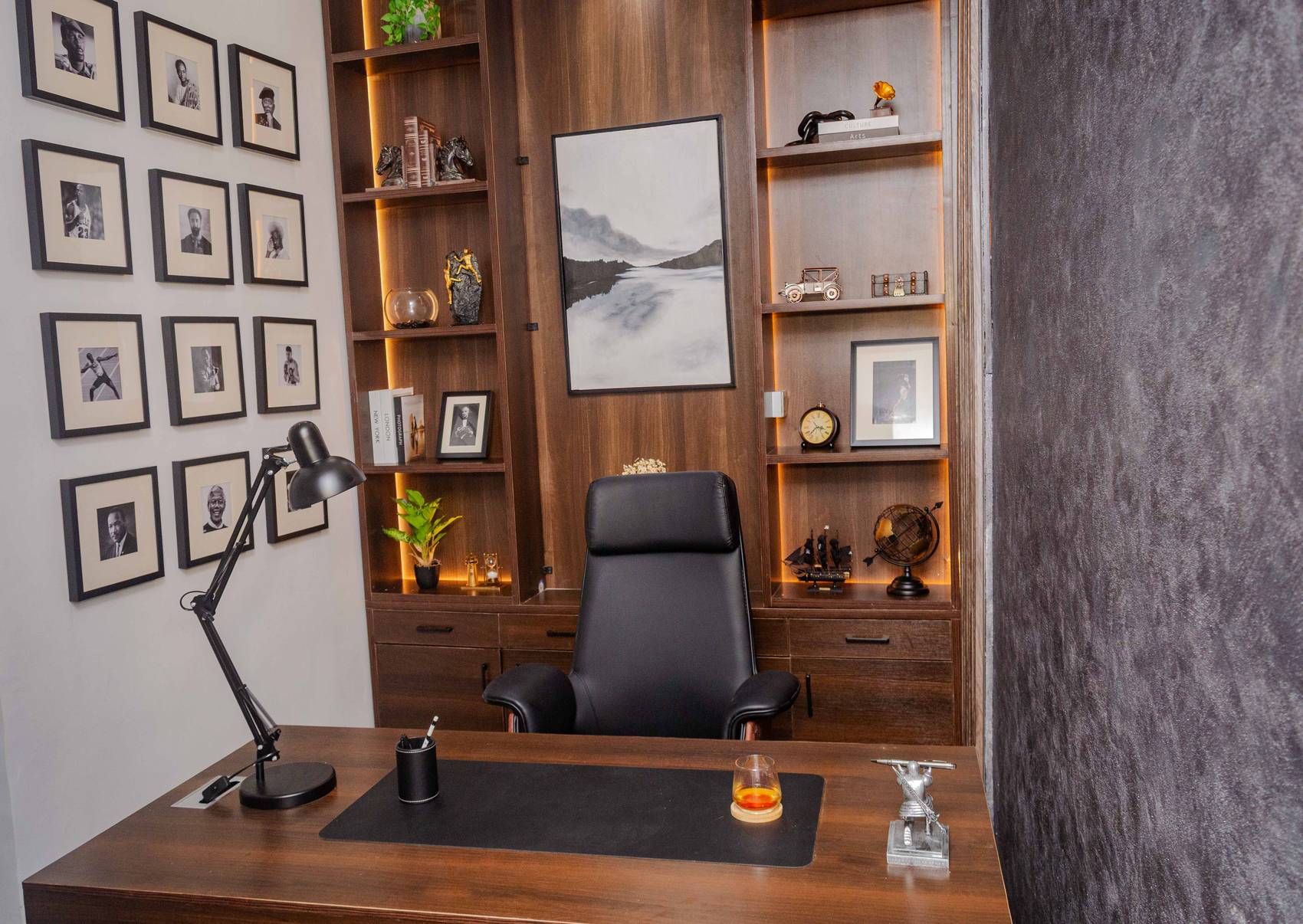 Seat of Legends — executive study with lit shelving and a portrait wall